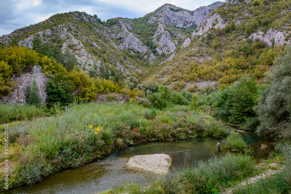 fisherman in the mountain river