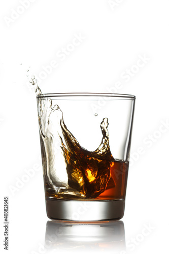 Glass of whiskey with splashes