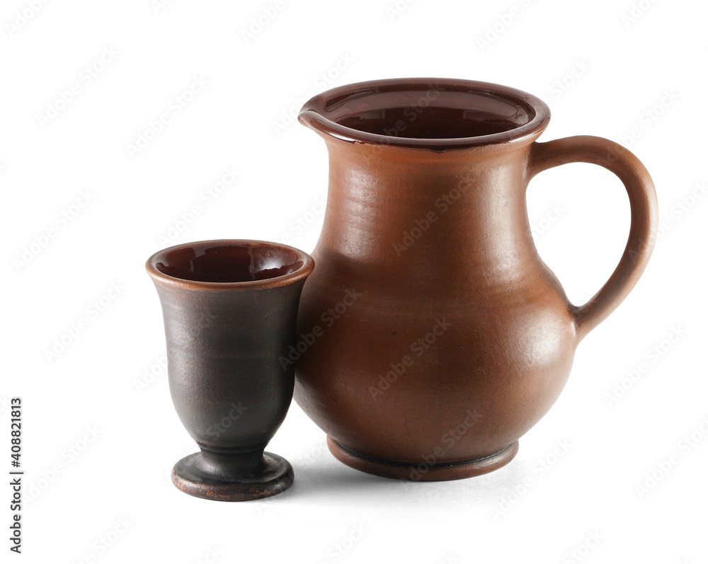 Clay jug and clay cup isolated on white background. Suitable for drinks that need coolness (e.g. milk or wine). Pottery of the Vladimir region, the city of Suzdal.