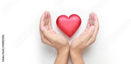 Hands holding red heart. heart health donation concepts