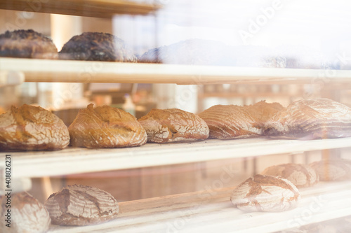 Bakery presents organic bread in the window display. Bäckerei presentiert bio Brot in der Fensterauslage.  photo