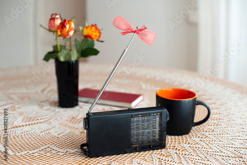 Fotografie Still life with retro radio receiver, flowers, coffee cup and book