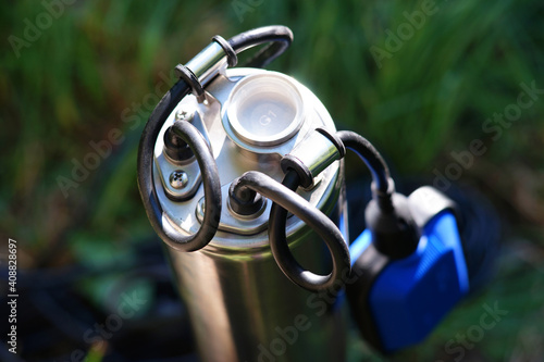 Well pump top with black cable and float switch.  The outlet thread of the downhole pump. Automatic dry run protection. The pump thread is covered with a white cover.