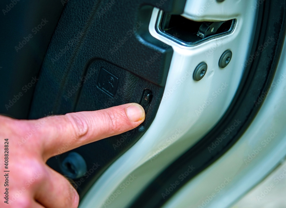 Safety travel concept, a father hand press child lock button on rear