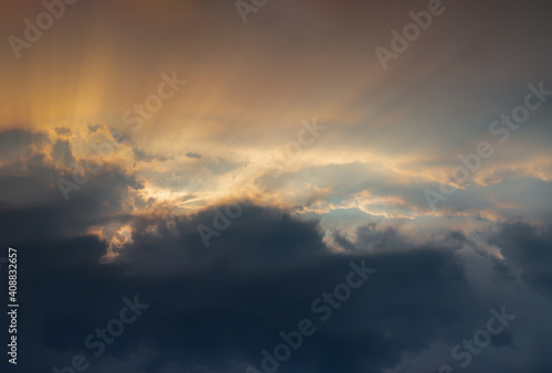 The sun's rays passing through the clouds and shining form an interesting light pattern against the sky evening. Copy space, No focus, specifically. specifically. © num