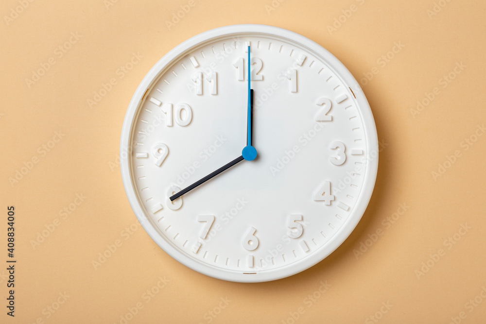 white wall clock with blue second hand show eight o'clock white wall clock with blue second hand show eight o'clock