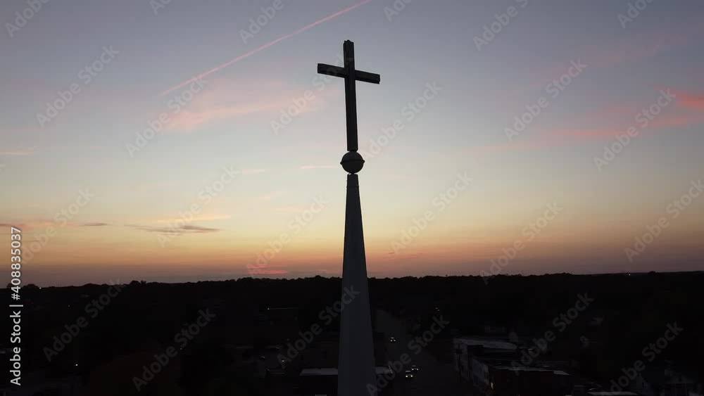 Drone orbit around cross on a church steeple with a gorgeous sunset over the city skyline. Drone orbit around cross on a church steeple with a gorgeous sunset over the city skyline.