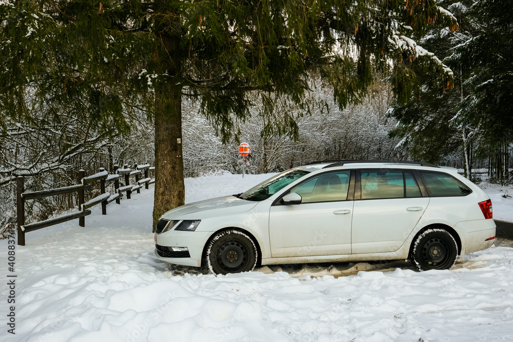 White car parked in the snow White car parked in the snow