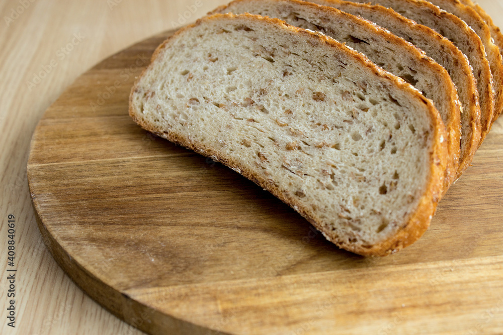 Multigrain bread. Fresh bakery. Slices of multigrain bread on a cutting board. Close-up. Flat layout.