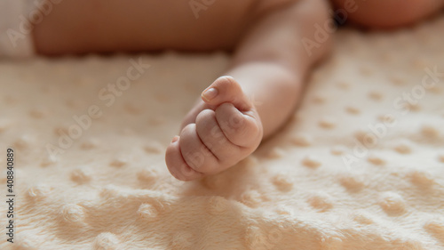 Tiny newborn 2 months or 6 weeks old baby's hand. Close-up baby's fistSelective focus