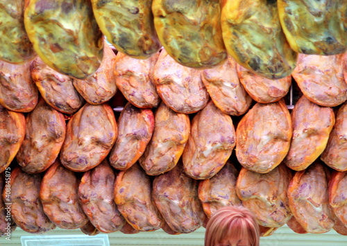 Whole hams in a row, at different ages and colors, in relation to the colors of the hair of the seller