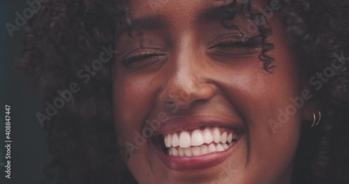 Attractive african woman smiling outdoor in windy day 