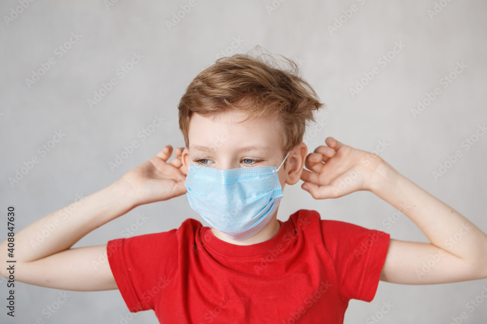 Little boy wearing a mask against corona virus covid-19, 2019-nCov. Kid in a surgical bandage or respirator during corona virus and flu outbreak. Child in a medical mask. quarantine.
