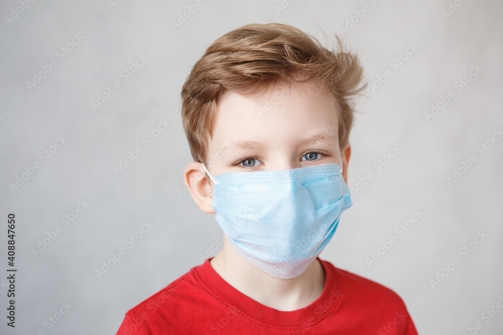 Little boy wearing a mask against corona virus covid-19, 2019-nCov. Kid in a surgical bandage or respirator during corona virus and flu outbreak. Child in a medical mask. quarantine. Little boy wearing a mask against corona virus covid-19, 2019-nCov. Kid in a surgical bandage or respirator during corona virus and flu outbreak. Child in a medical mask. quarantine.