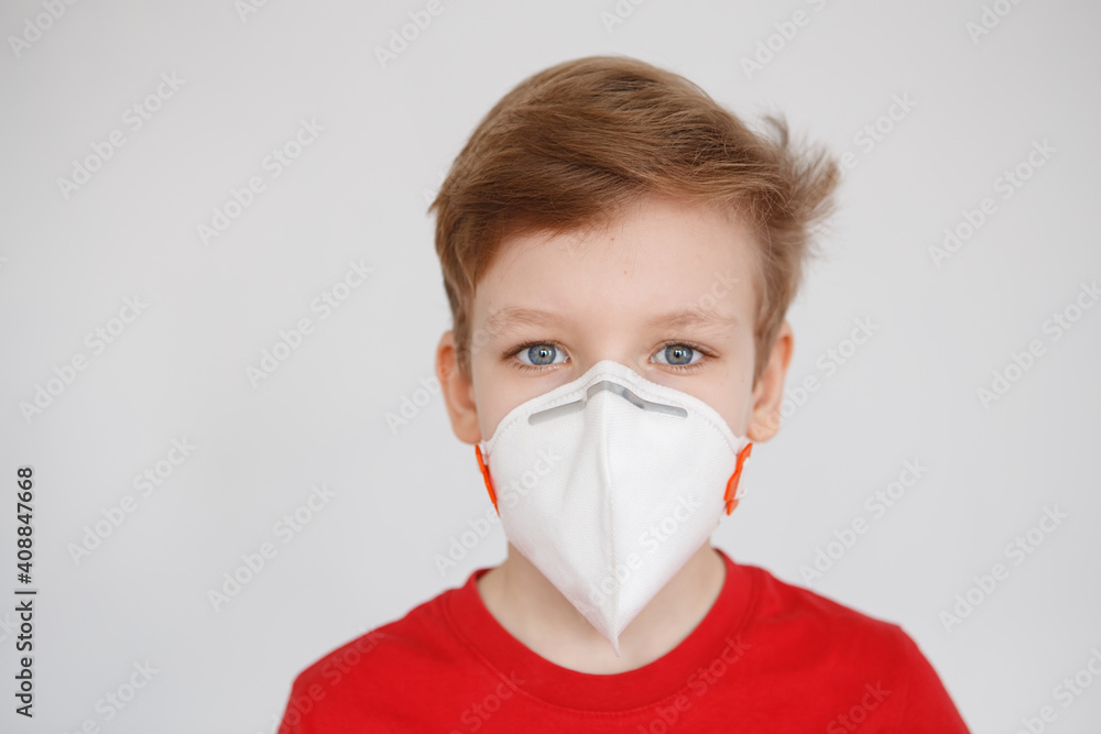 Little boy wearing a mask against corona virus covid-19, 2019-nCov. Kid in a surgical bandage or respirator during corona virus and flu outbreak. Child in a medical mask. quarantine. Little boy wearing a mask against corona virus covid-19, 2019-nCov. Kid in a surgical bandage or respirator during corona virus and flu outbreak. Child in a medical mask. quarantine.