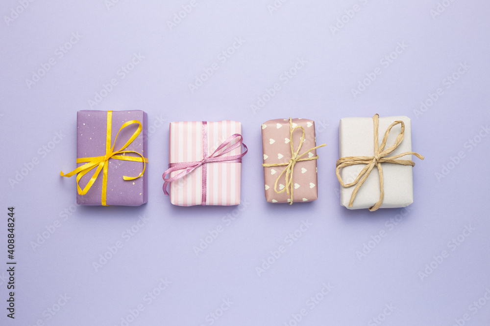 Purple gift boxes on purple background. flat lay, top view, copy space