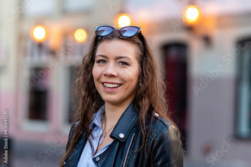 portrait of a cute and gorgeous women posing on blurred strret background with bokeh light photo