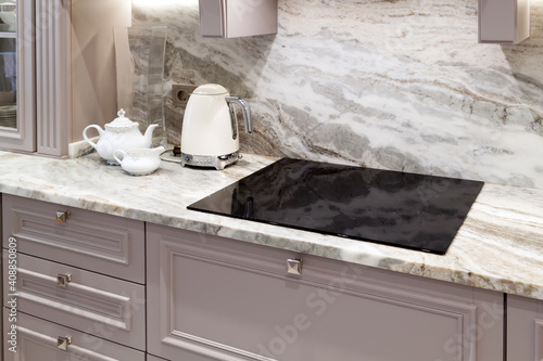 Bilde på lerret beautiful closeup of custom designed kitchen, with marble looking quartz countertop and backsplash