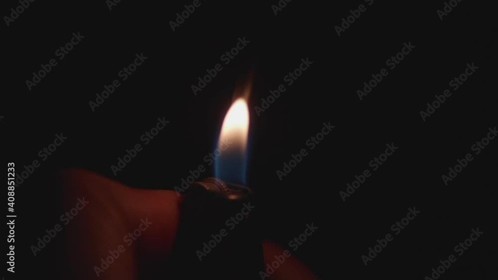 Man uses a gas lighter. Burning flame with flint sparks. Close up footage of fire in hand. Accessory for smoking people. Man uses a gas lighter. Burning flame with flint sparks. Close up footage of fire in hand. Accessory for smoking people.