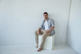 A man in a photo studio on a white background space for text 