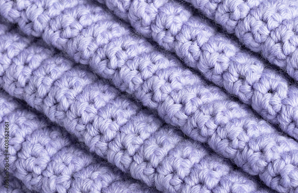 textured knitted background lavender color. Intertwined threads on a knitted blanket textured knitted background lavender color. Intertwined threads on a knitted blanket