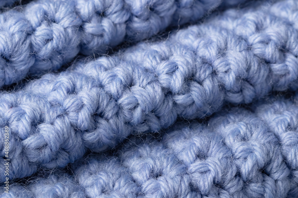 textured knitted background lavender color. Intertwined threads on a knitted blanket