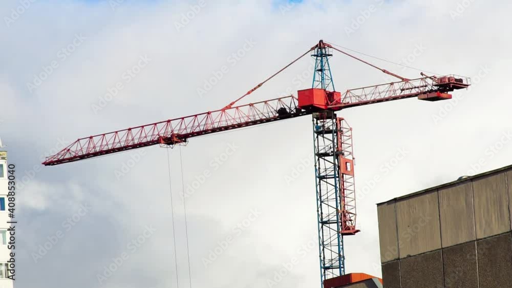 Construction crane on the background of the cloudy sky. Construction crane on the background of the cloudy sky.