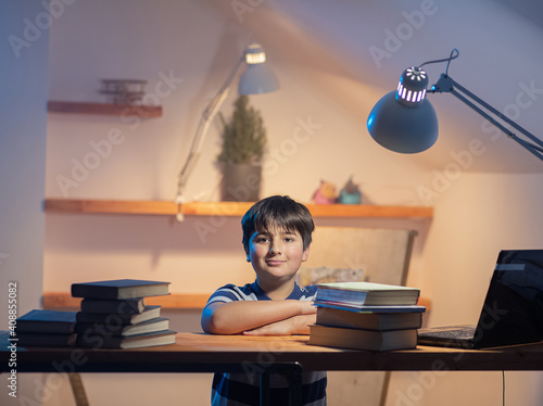 Fotografie Portrait of a boy in his room at a work table