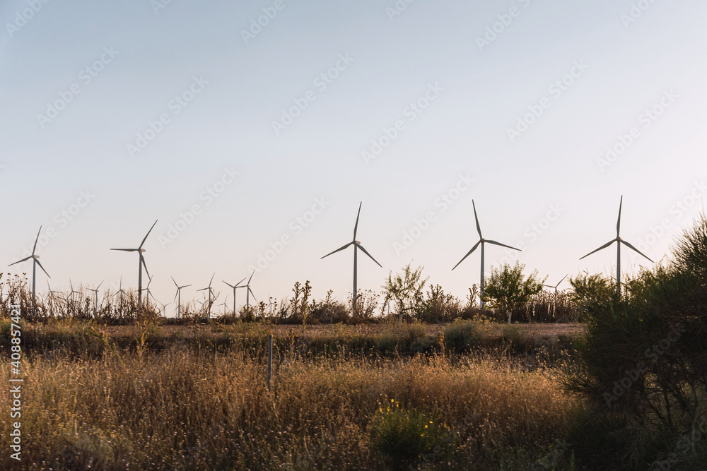 Wind turbines on beautiful sunny summer day. Wind Turbine Farm. Green ecological power energy generation Wind turbines on beautiful sunny summer day. Wind Turbine Farm. Green ecological power energy generation
