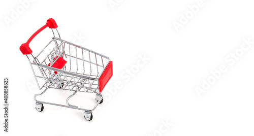 Empty supermarket shopping trolley on white background with copy space © Victoria