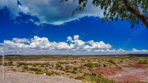 El chocon area desertic landscape, taken on a sunny warm morning under a blue sky with a few white clouds.   photo