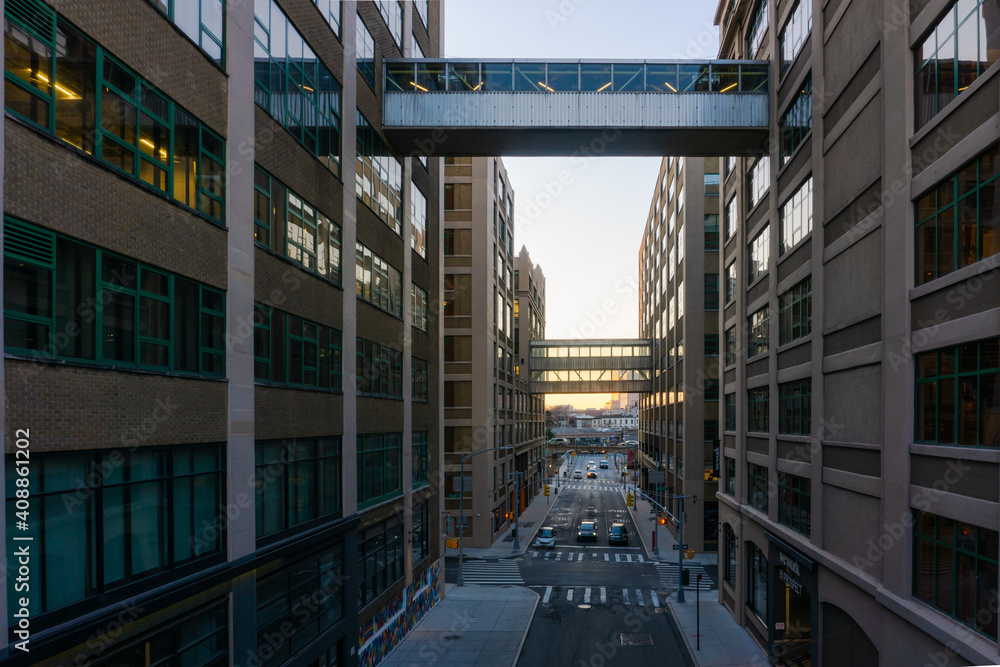 New York, USA - January 21, 2021: Building connected by sky bridge in Dumbo, Brooklyn. Street separating buildings