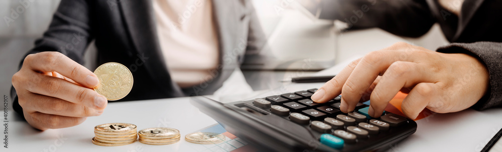 Healthcare costs and fees concept.Hand of smart doctor used a calculator for medical costs in modern hospital Healthcare costs and fees concept.Hand of smart doctor used a calculator for medical costs in modern hospital