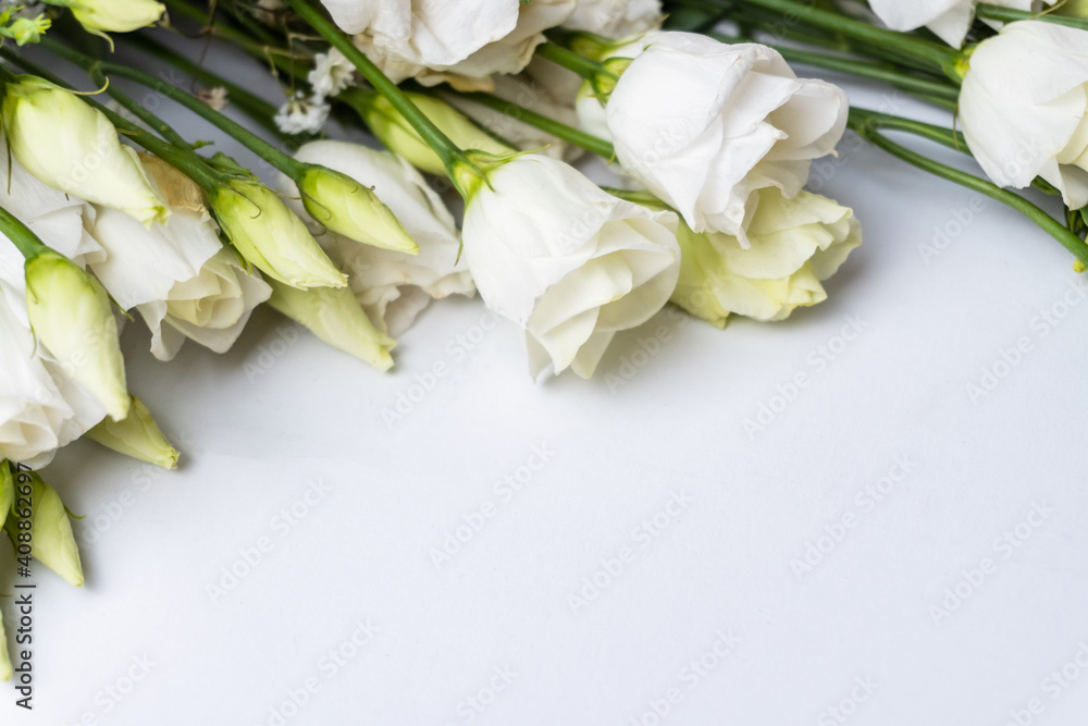 Fototapeta premium White eustoma flowers bunch. Place for text. Postcard. Selective focus.