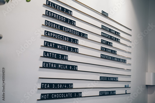 White wall of a cafe with a typesetting or hanging menu on it
