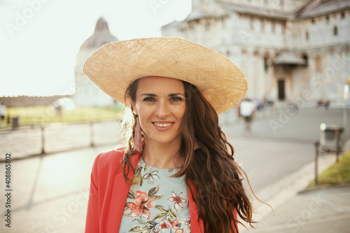 happy trendy tourist woman in floral dress enjoying promenade