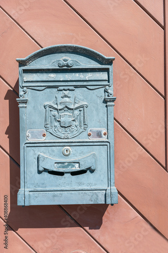 old mailbox with logo on wooden background