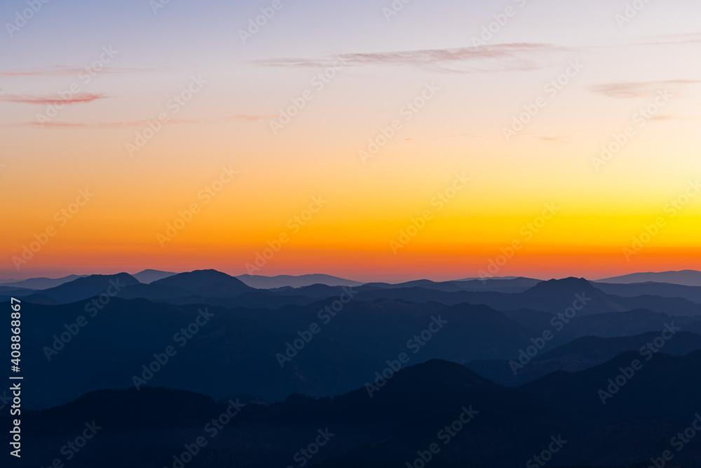 Scenic landscape of the mountains and the forest at sunset