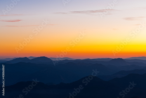 Scenic landscape of the mountains and the forest at sunset