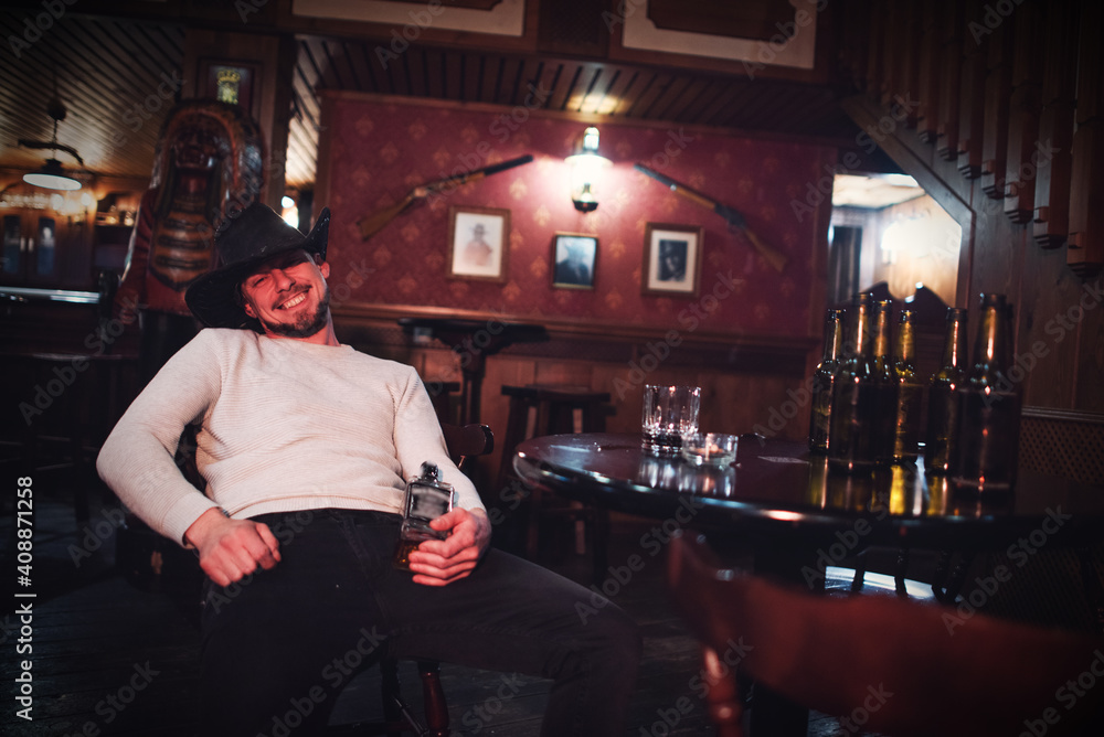 Cowboy smoking and drinking in a bar Cowboy smoking and drinking in a bar