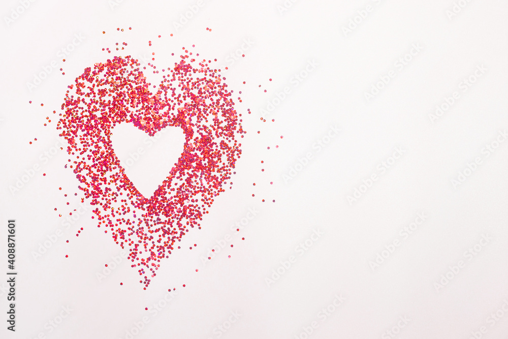 heart of gold and red sequins on a white background