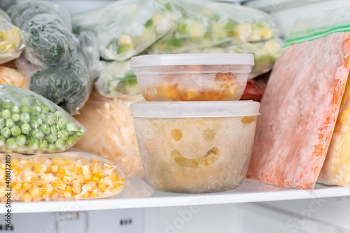 Frozen food in the freezer. Frozen soup, vegetables, ready meals in the freezer