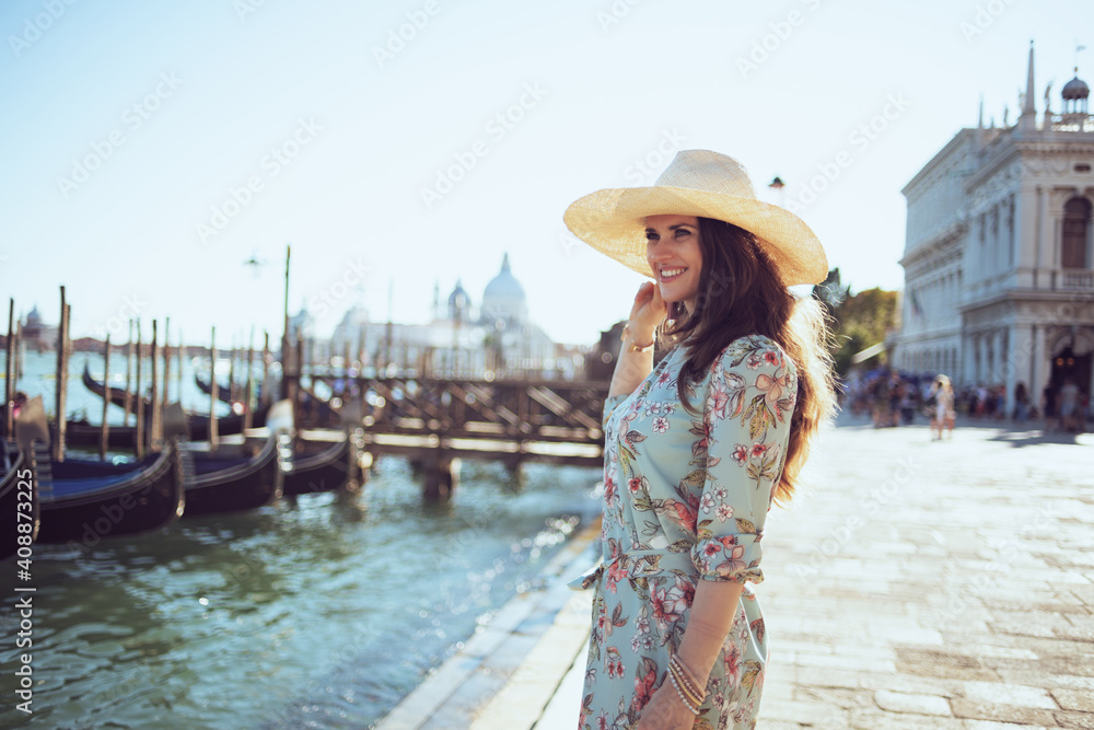 happy stylish woman in floral dress exploring attractions