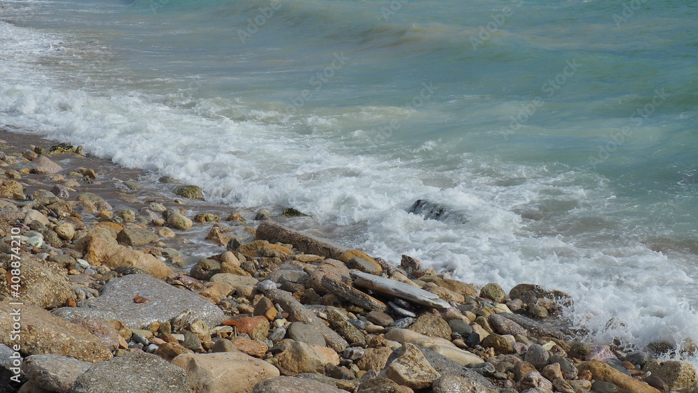 Mediterranean rocky beach with wavy sea in a cloudy morning Mediterranean rocky beach with wavy sea in a cloudy morning