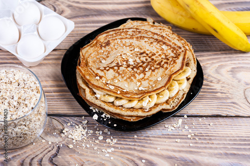 Oat pancakes with banana. Step by step cooking process. Mix bananas with milk, eggs and oats, salt