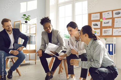 African woman talking to coworkers. Millennial business people working in office and thinking on project together. Female team manager, company owner, CEO or mentor suggesting ideas in group meeting