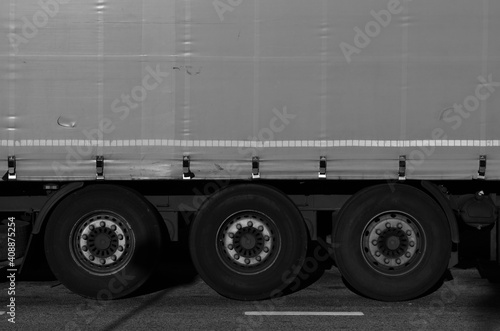 Closeup of cargo truck semi-trailer wheels and cargo, logistics background image photo