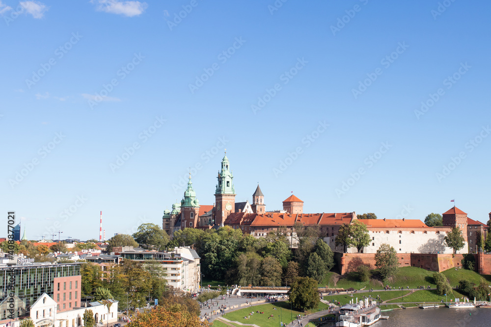 View of a Wawel Castle and Wawel cathedral in the sun over the Vistula river on sunny afternoon, Krakow, Poland
