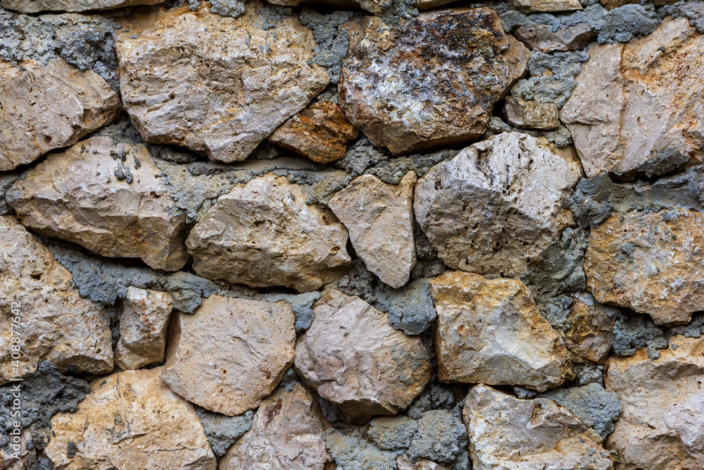 Elements of masonry of a stone wall made of natural stone, with the use of lime mortar.