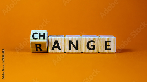 Change range symbol. Turned a cube and changed the word 'change' to 'range'. Beautiful orange background. Copy space. Business and change range concept.